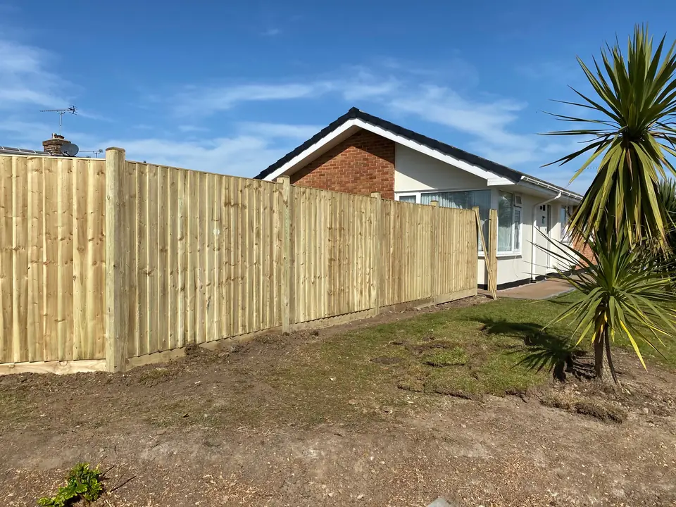 Timber closeboard boundary fence beside a bungalow